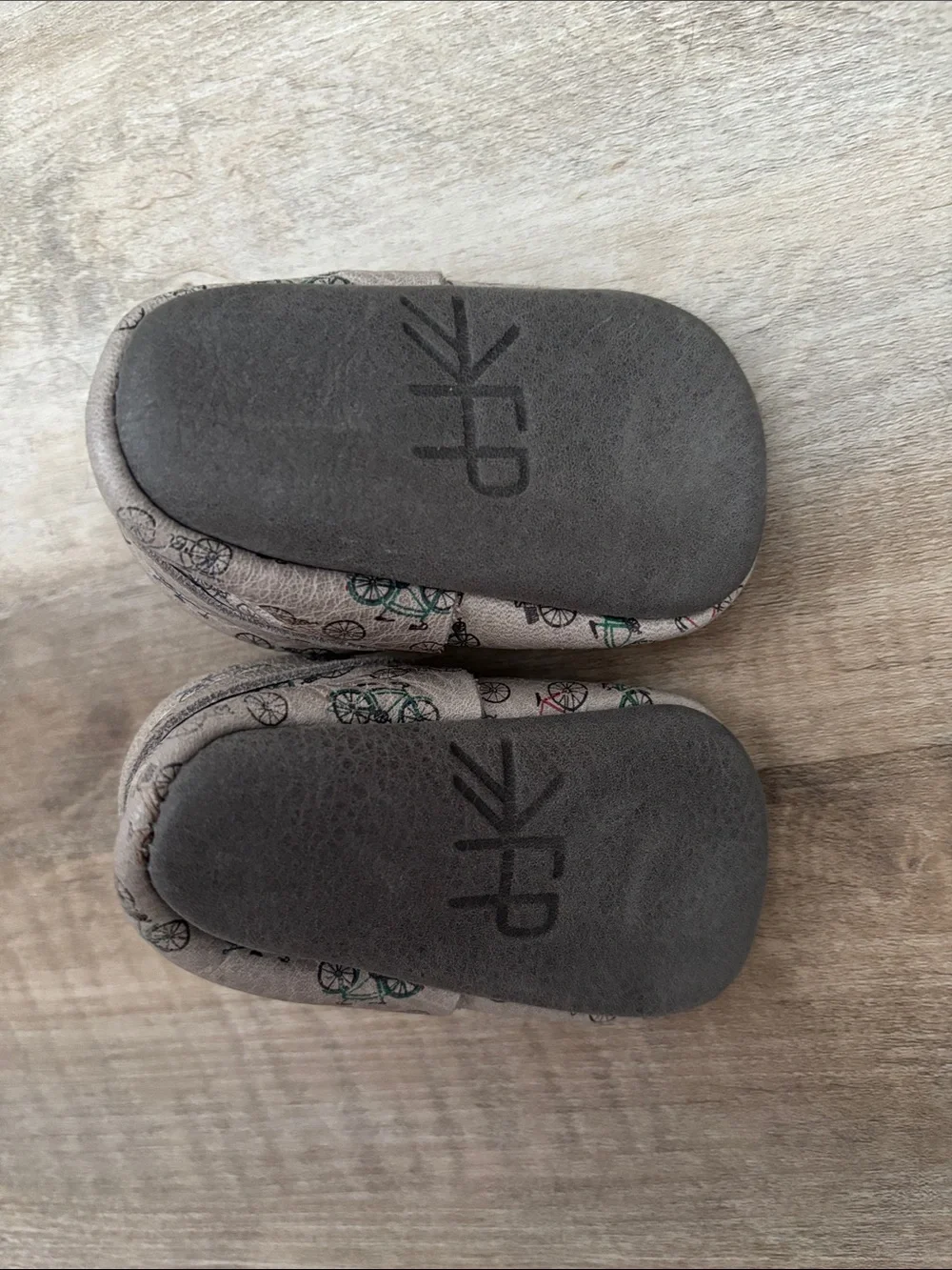 Freshly Picked Beige Baby Moccasins with Multicolor Bicycle Print